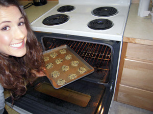 CoconutGal putting elanaspantry.com Gluten Free Chocolate Chip Cookies in the oven